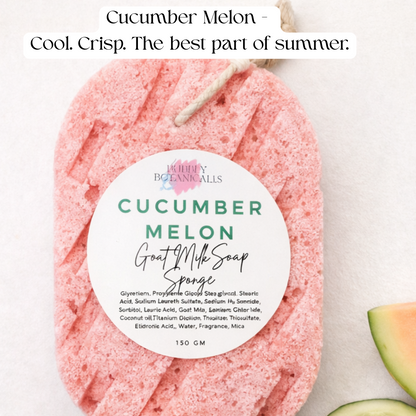 A pink textured goat milk infused bath sponge labeled 'Cucumber Melon Goat Milk Soap Sponge' by Bubbly Botanicals shown on a white background with cucumber slices and a melon slice as props, and text at the top reading 'Cucumber Melon - Cool. Crisp.