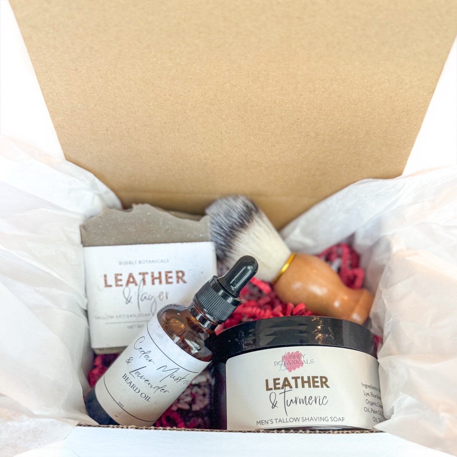 Grooming products including a jar, bottle, and brush in a box labeled 'Leather & Lavender'.