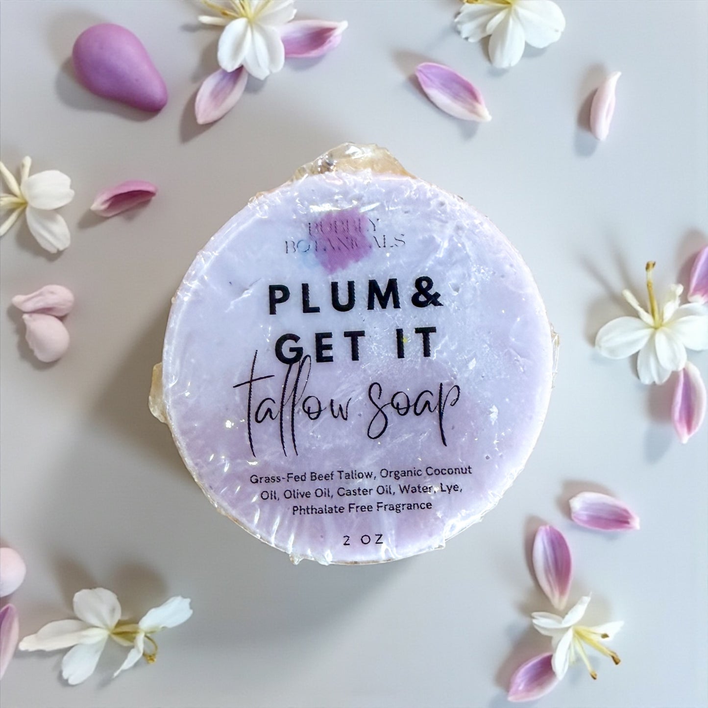 Tallow soap with 'Plum & Get It' text surrounded by flowers on a light background