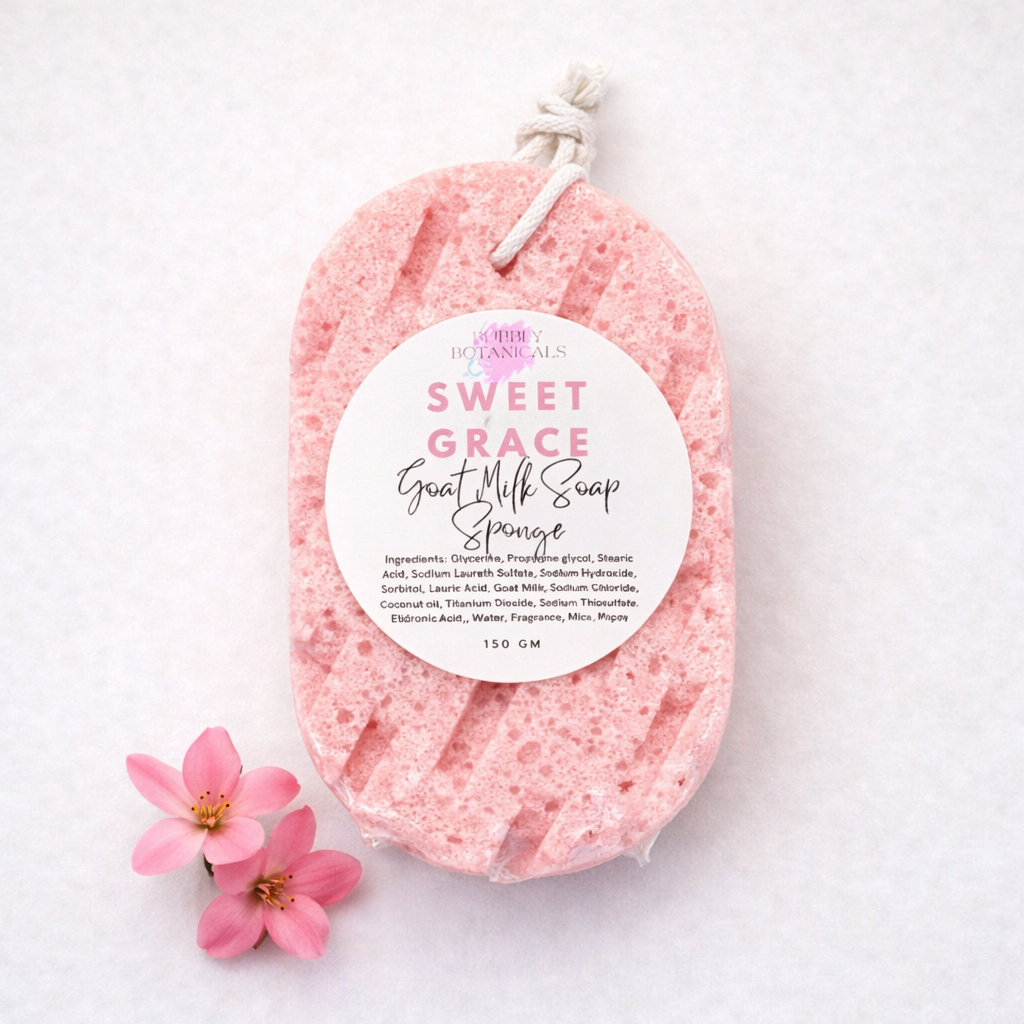 Pink goat milk soap sponge with a label on a white background